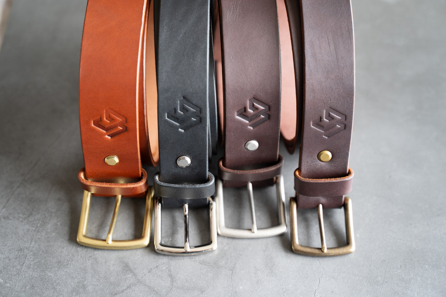 Four vertical photos showcasing the forging, plating, and inspection of high-quality brass hardware at Buckleguy's factory, used in the Timeless Belt.