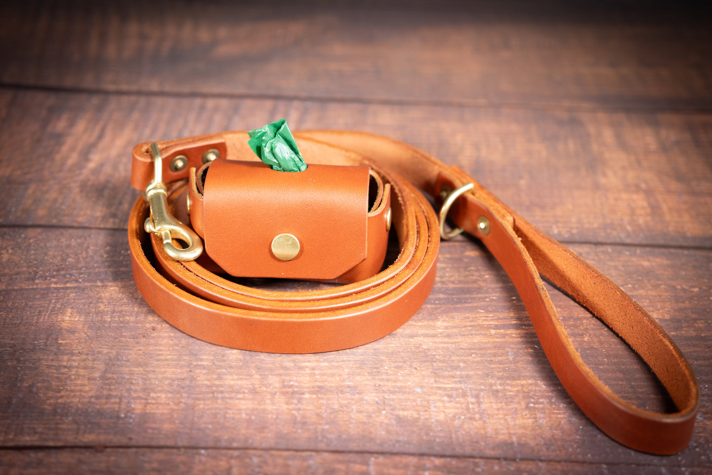 A nice choice of chestnut and black dog poop holder with quality leather.