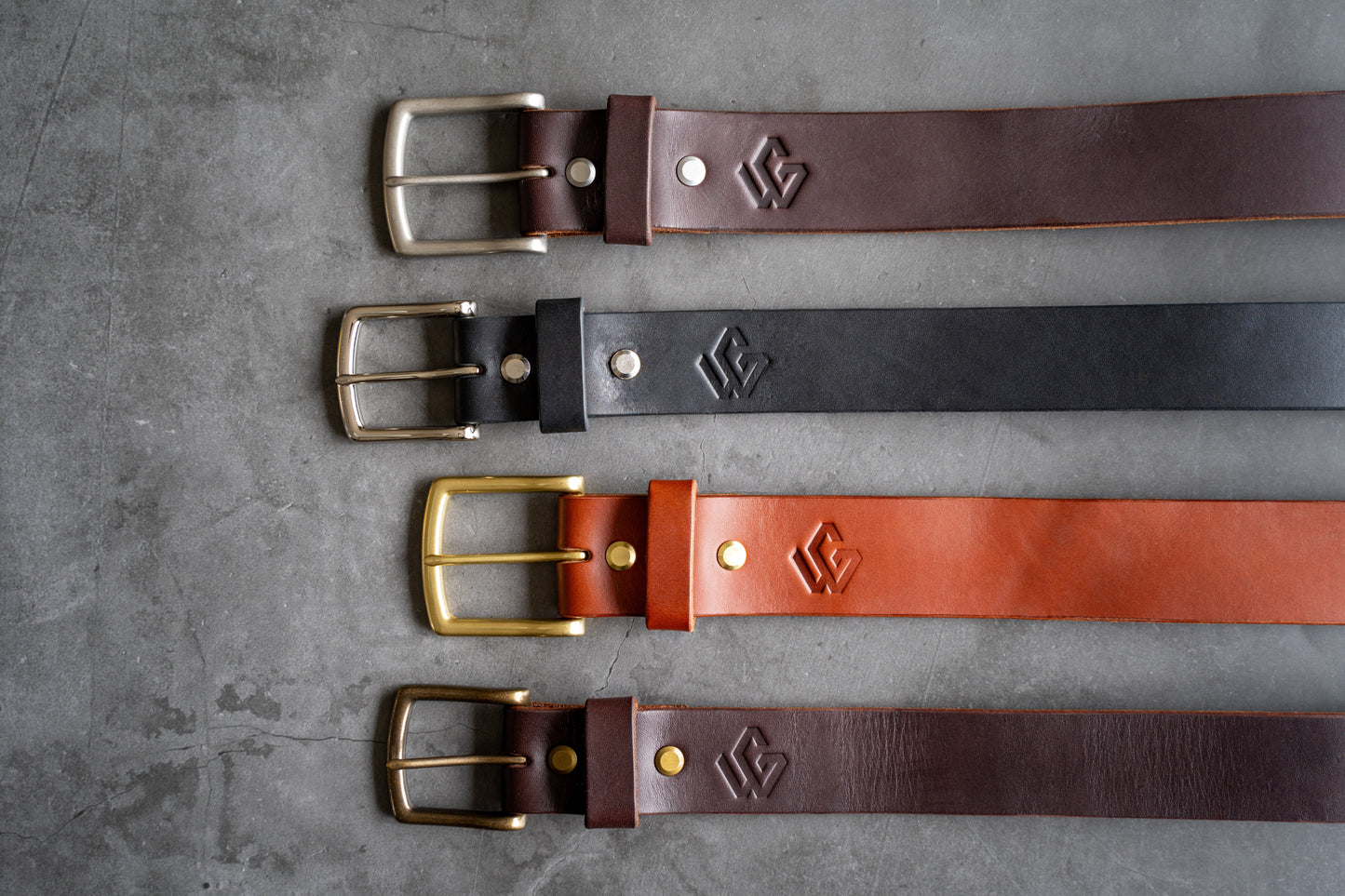 Four Timeless Belt in dark brown, black and medium black leather with their hardware