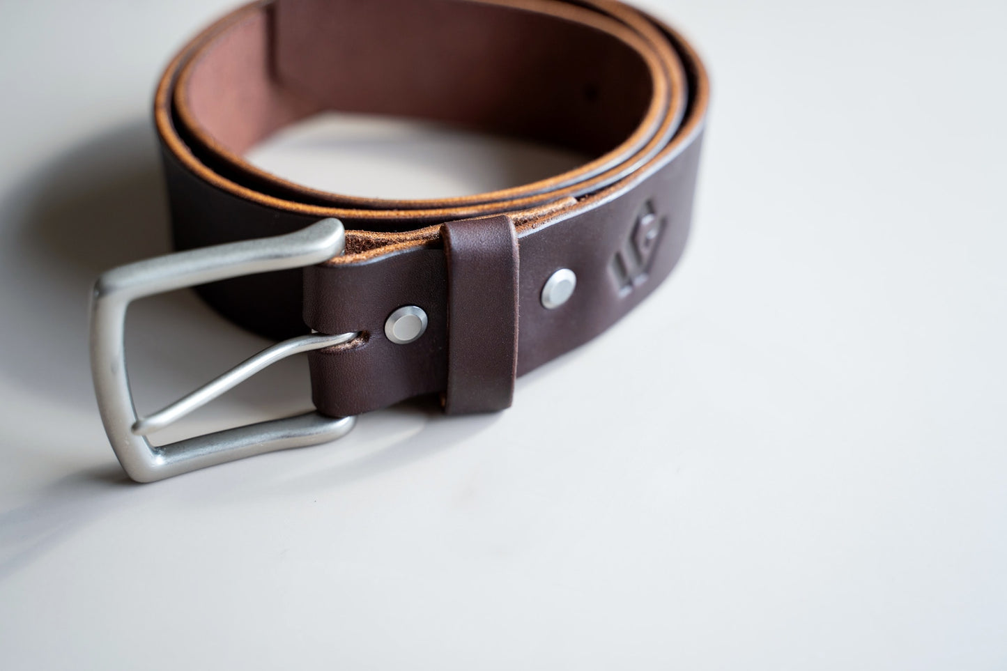 Side-by-side images showing the thickness of Timeless Belt leather in 4mm and 5/32 inch, emphasizing its robust and long-lasting quality.